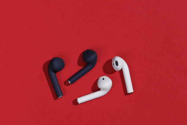 istock True wireless bluetooth headphones or earbuds with on bright red background. Top view 1312241605