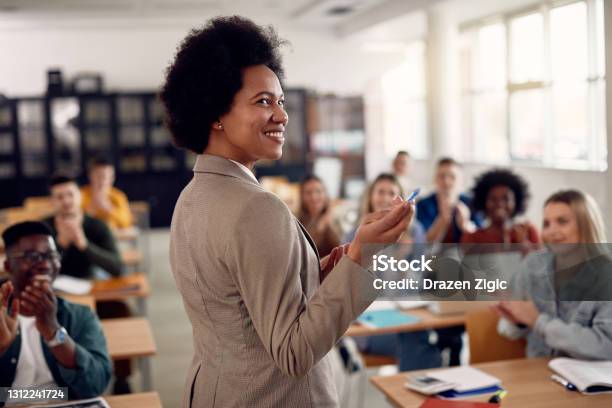 Happy Black Techer Getting Applause From Her Students After Giving Them A Lecture At The University Stock Photo - Download Image Now