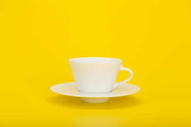 istock White ceramic coffee or tea cup on yellow background with space for text 1312241753