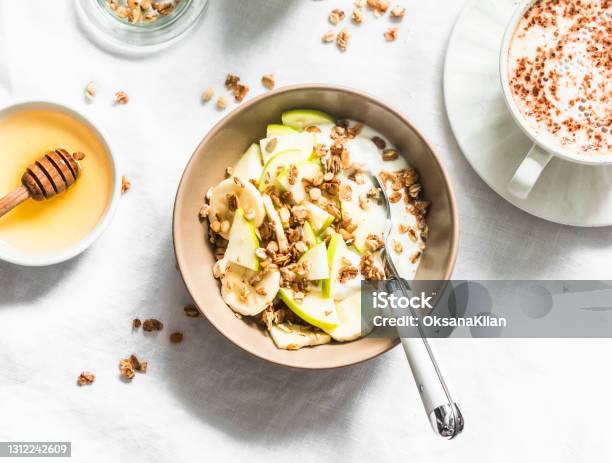 Greek Yogurt With Granola Banana Apple Honey On A Light Background Top View Delicious Breakfast Stock Photo - Download Image Now