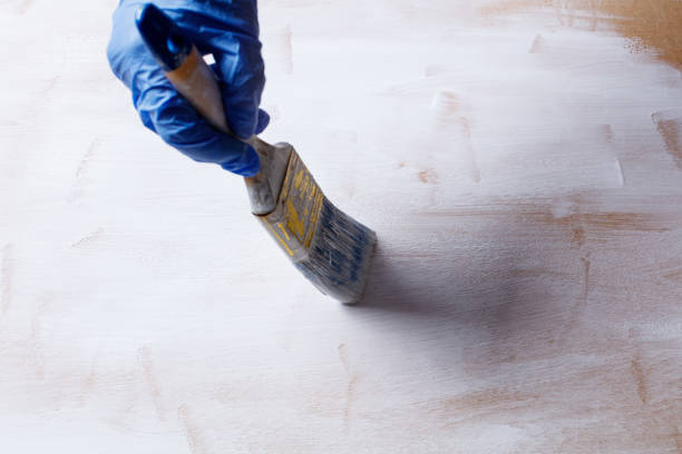istock Painting wooden panel with white paint 1312243753
