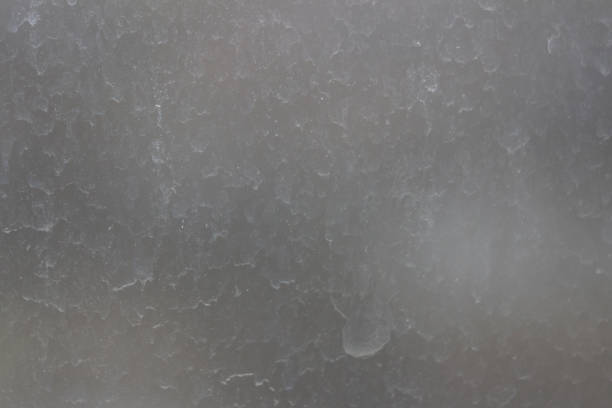 Blurred streaks of dust and dirt on the unwashed window.