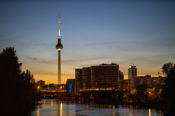 Berlin skyline with famous TV tower at Alexanderplatz at night Berlin skyline with famous TV tower and spree river at Alexanderplatz. Dramatic sky in twilight during blue hour at dusk, Germany. east berlin photos stock pictures, royalty-free photos & images