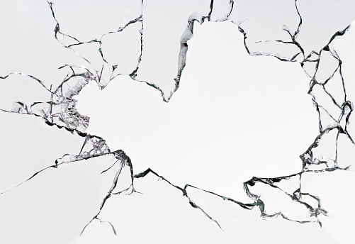 Cracked broken glass on a white background. Damaged window texture