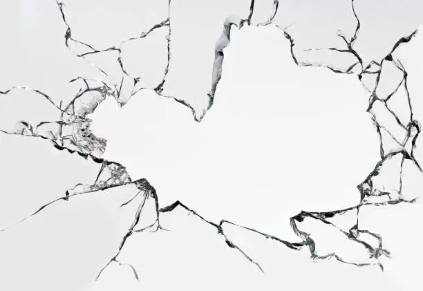 Cracked broken glass on a white background. Damaged window texture.