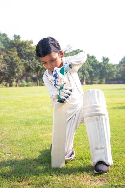 istock Confident boy wearing cricket uniform and playing Cricket 1312248791