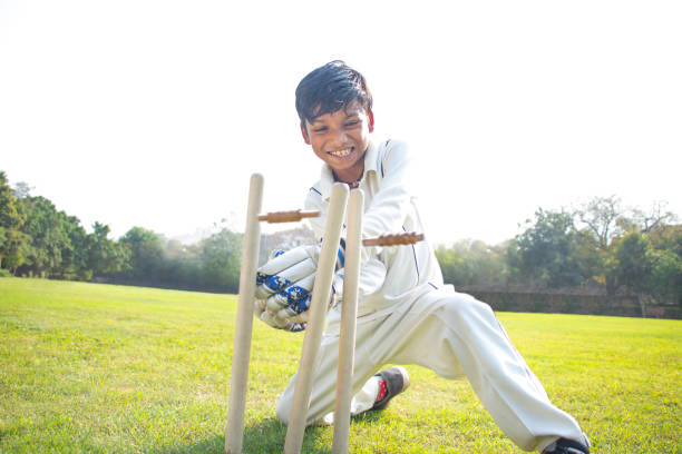 istock a boy wicket keeper stumping during cricket game 1312248792