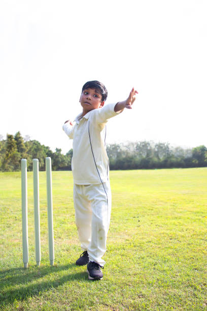 istock Young boy bowling leg spin in a cricket 1312248865