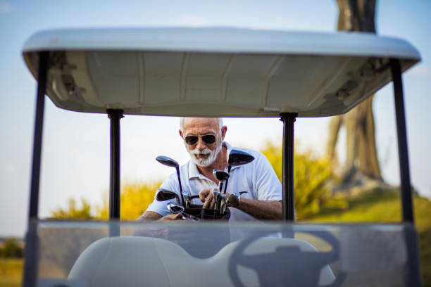 istock Senior man packs for golf. 1312248887