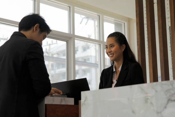istock Receptionist is service customer at counter. 1312248926