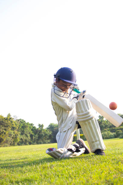 istock Young boy batting in protective gear during a cricket 1312249054