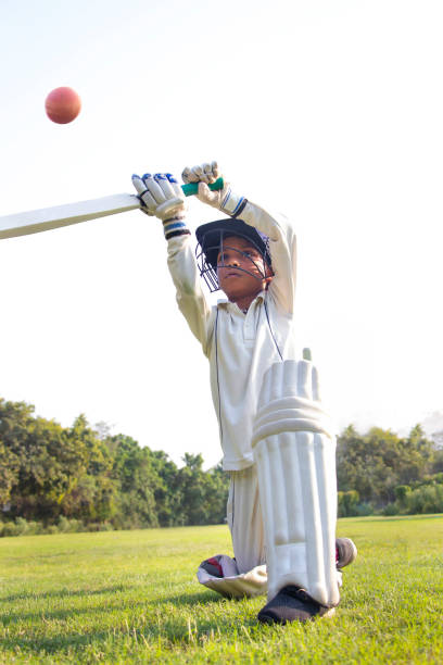 istock Young boy batting in protective gear during a cricket 1312249072