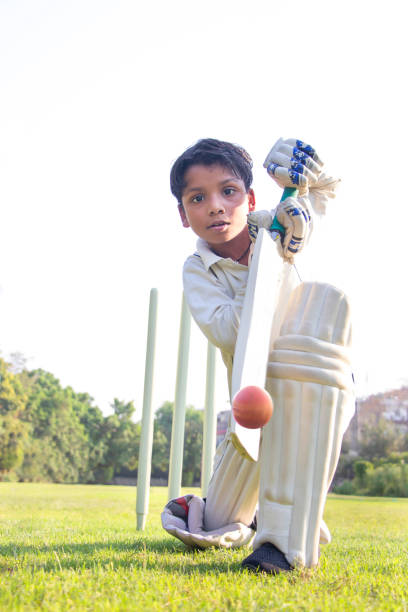istock Young boy batting in protective gear during a cricket 1312249591