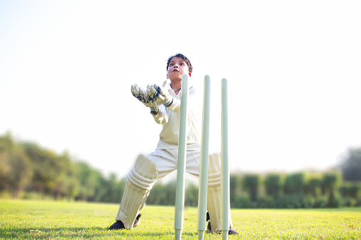 a boy wicket keeper during cricket game