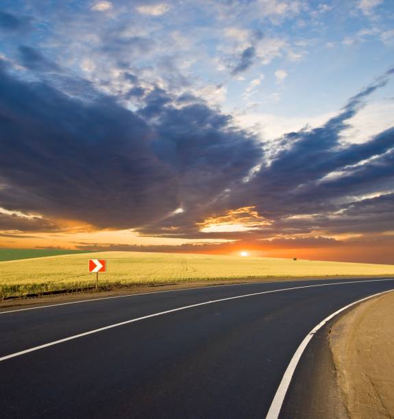 istock asphalt road turn at the sunset 1312250206