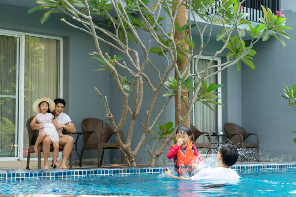 istock Father and son play at swimming pool. 1312251494