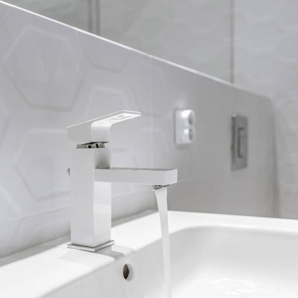 istock Modern white bathroom faucet, close-up 1312252342