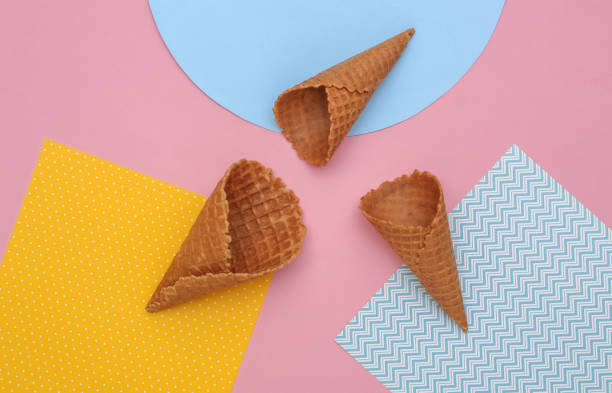 istock Ice cream waffle cones on creative colorful paper background, top view. Flat lay minimal composition 1312253754