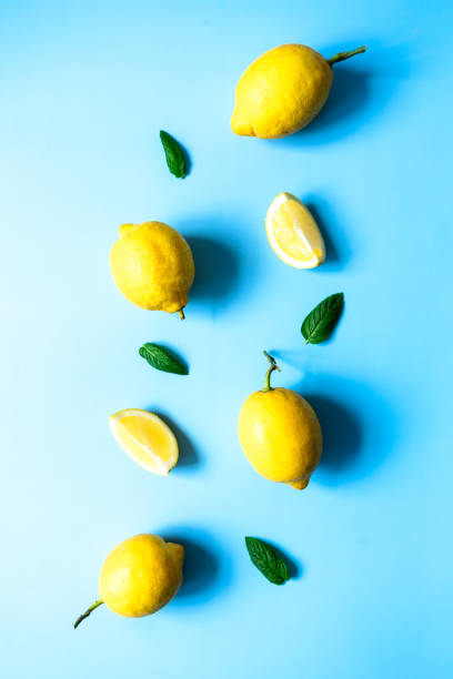 istock Fresh lemons and peppermint leaves on a blue background 1312254059