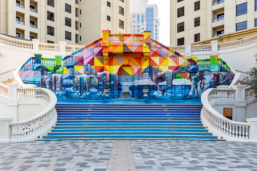 Dubai, UAE, 22.02.2021. A Sea of Horses colorful street art mural on palatial style staircase on JBR The Walk, with horses galloping in the sea which represents Dubai\