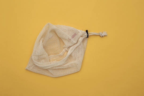 istock Eco cotton bag on yellow background. Top view 1312255225