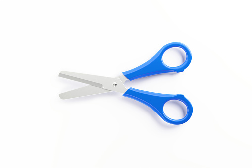 Purple pair of scissors isolated on white background