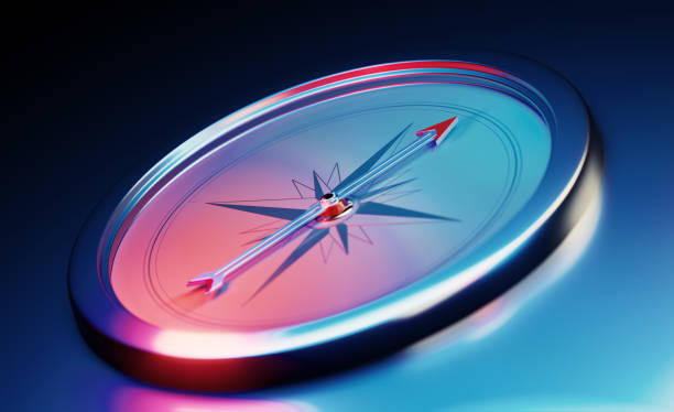 Compass Sitting Over Metallic Dark Blue Background Compass sitting over dark blue metallic background. Horizontal composition with copy space. navigational equipment stock pictures, royalty-free photos & images