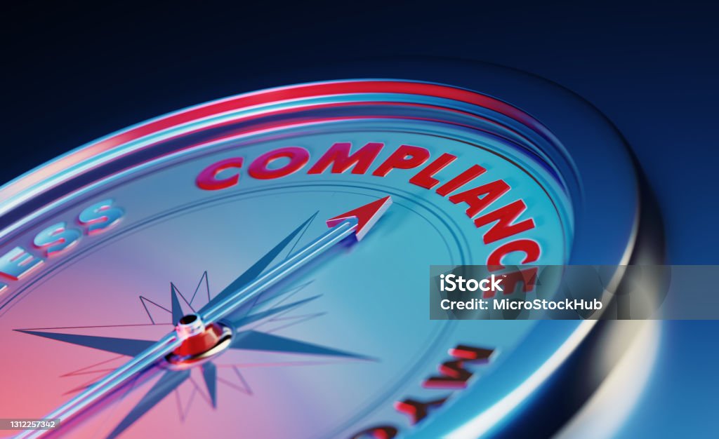Compliance Concept: The Arrow of The Compass Pointing The Compliance Word Over Dark Blue Metallic Background The arrow of the compass is pointing the compliance word over dark blue metallic background. Horizontal composition with copy space. Compliance concept. Obedience Stock Photo