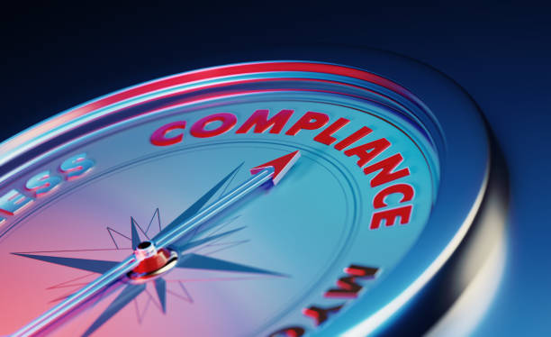 compliance concept: the arrow of the compass pointing the compliance word over dark blue metallic background - obedience imagens e fotografias de stock