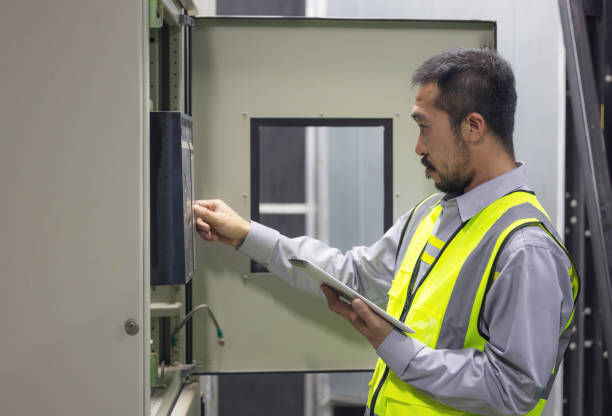 istock Close Up Hand Of Engineer Or Electrician Man Working Check The Electrical System With Tablet 1312258087