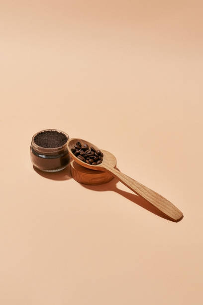 istock Cosmetological scrub beside wooden spoon with coffee 1312259629