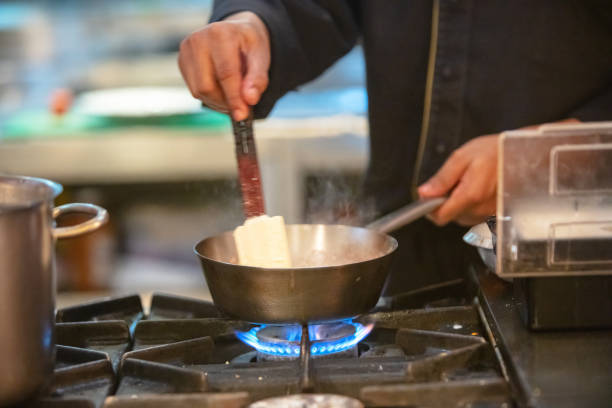 istock Chef prepares sauce on gas stove 1312259770