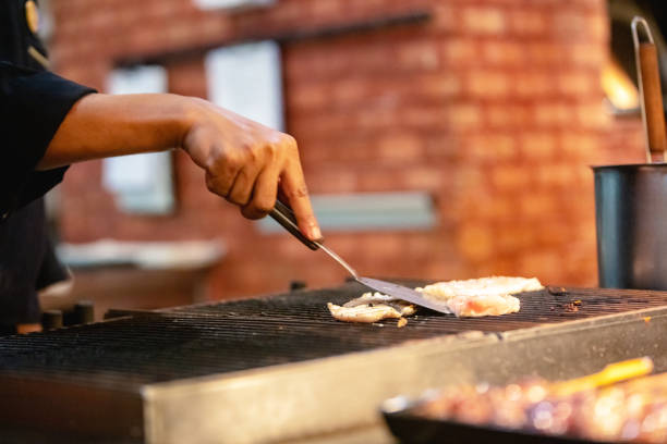istock Chef prepares fresh meat on grill 1312259788