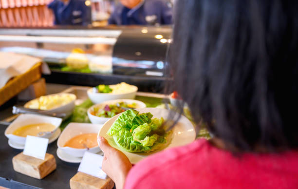 istock Woman pours the salad into a plate 1312259913