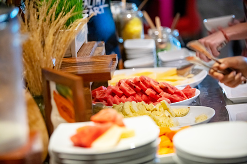 Close-up of chopped and served fruits at buffet