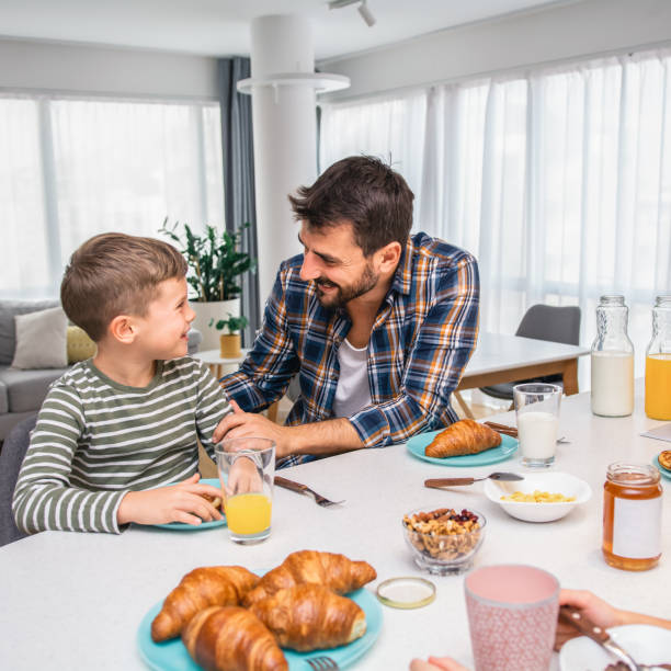 istock Little boy and his father having breakfast together 1312260325