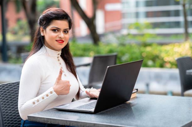 istock Young female professional working on laptop from cafe 1312260376