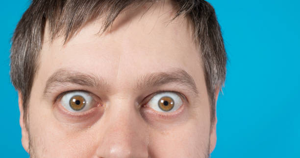 istock Surprised eyes of a man on a blue background text copy space. Big bulging eyes. 1312265010