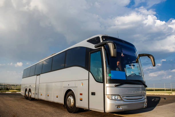 istock Bus staying in the parking lot under a blue sky with clouds 1312265273