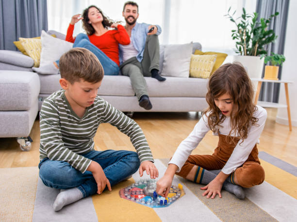 istock Cheerful children playing board games. 1312265282