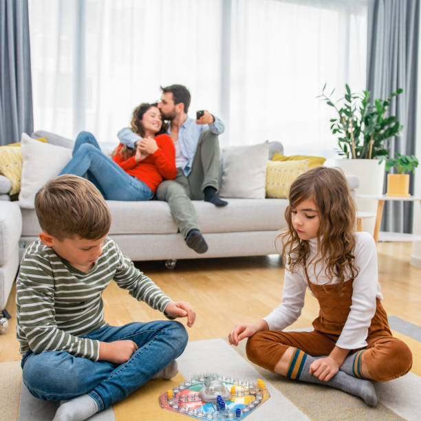 istock Cheerful children playing board games. 1312265518