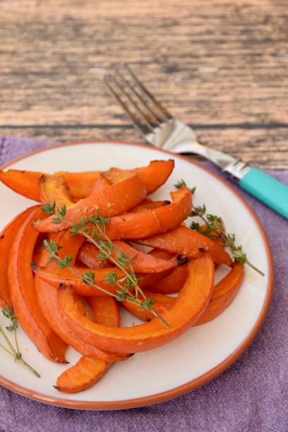 istock Sliced roasted red kuri squash with thyme 1312265692