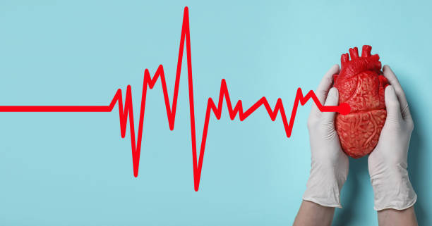 istock Doctor holding heart model on light blue background, top view 1312266403