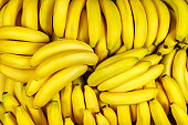 Background of many banana pieces, overhead view, studio food photography.