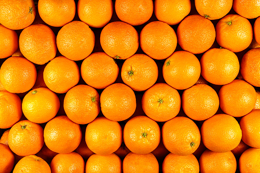 Background of many pieces of oranges, overhead view, studio food photography. Macro