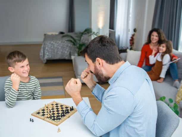 istock Father and son playing chess together 1312269762