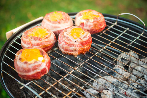 istock Making home made Beer Can Bacon Burgers on barbecue grill. 1312271063