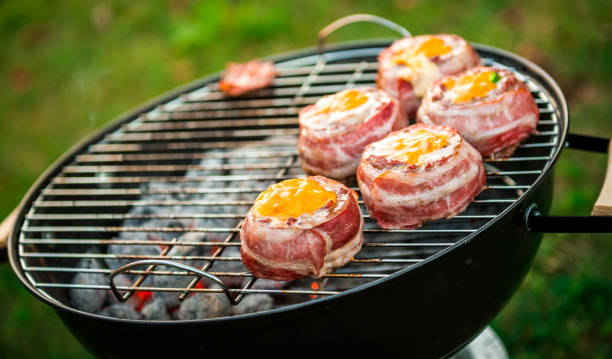 istock Making home made Beer Can Bacon Burgers on barbecue grill. 1312271072