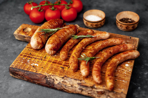 istock Various grilled sausages with spices on a stone table with copy space for your text. 1312271309