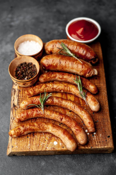 istock Various grilled sausages with spices on a stone table 1312271426